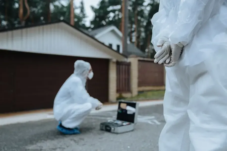 Mold remediation specialists in protective suits performing containment in Fairfax VA