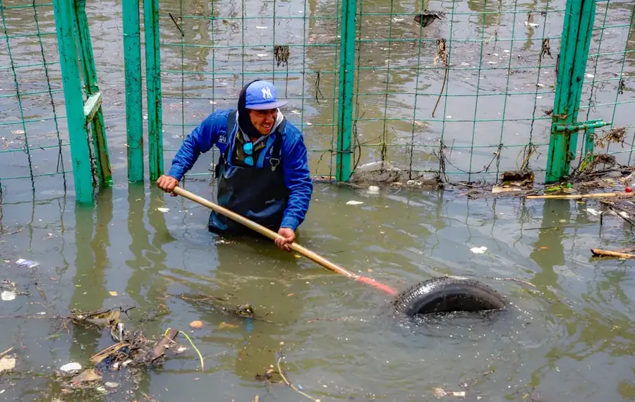 Restoration worker removing flood debris from contaminated water in Fairfax County VA